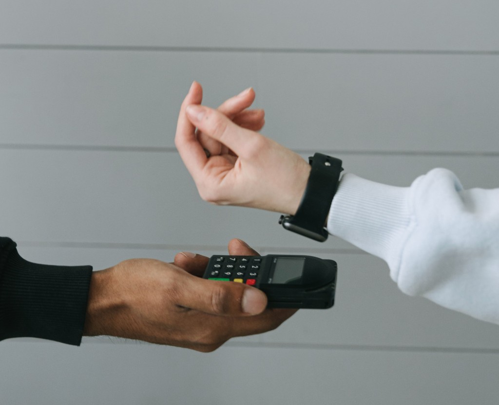Customer completing a contactless smartwatch payment at ecommerce checkout